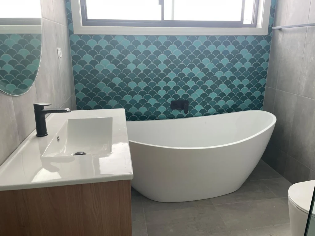 Bathroom tiling with blue fish-scale feature wall in Adelaide by First Quality Tiling
