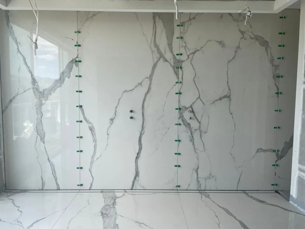 Large marble-look porcelain slab feature wall installed by First Quality Tiling in Adelaide