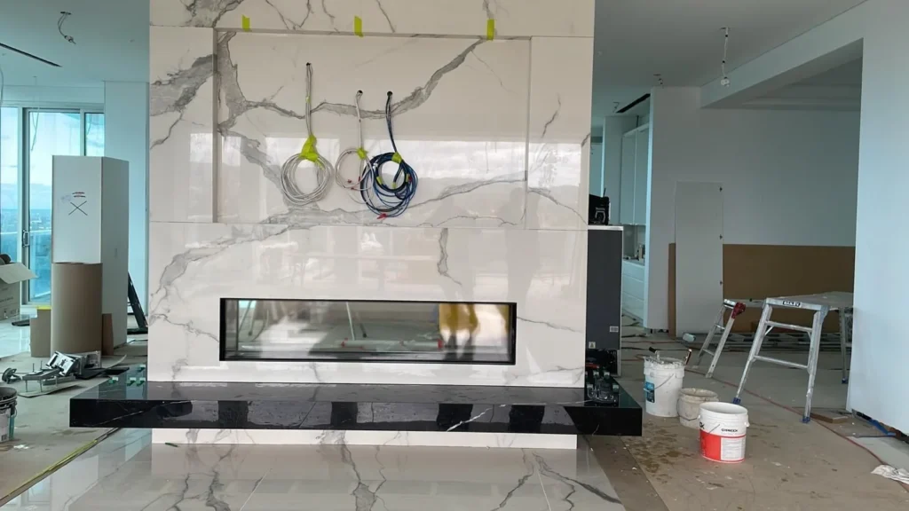 Marble-look fireplace feature wall tiling completed in Adelaide by First Quality Tiling