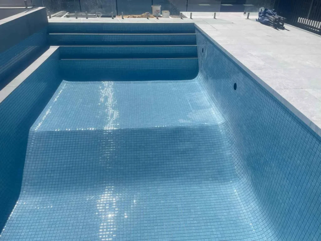 Blue mosaic swimming pool tiling completed by First Quality Tiling in Adelaide